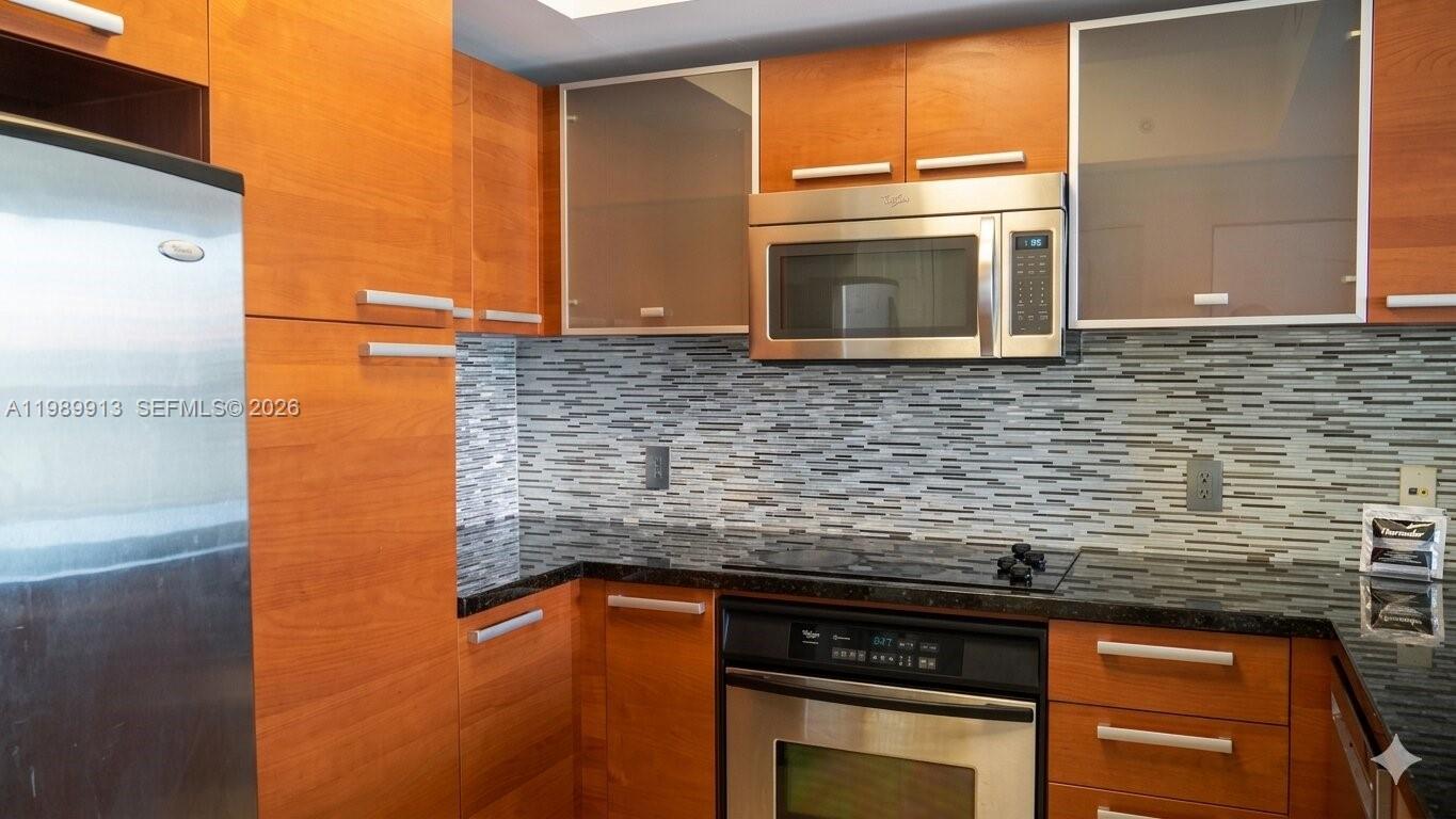 2030 Douglas Road, Unit 414 Coral Gables, FL 33134 - Photo 3 of 15 a kitchen with granite countertop cabinets stainless steel appliances and a counter space
