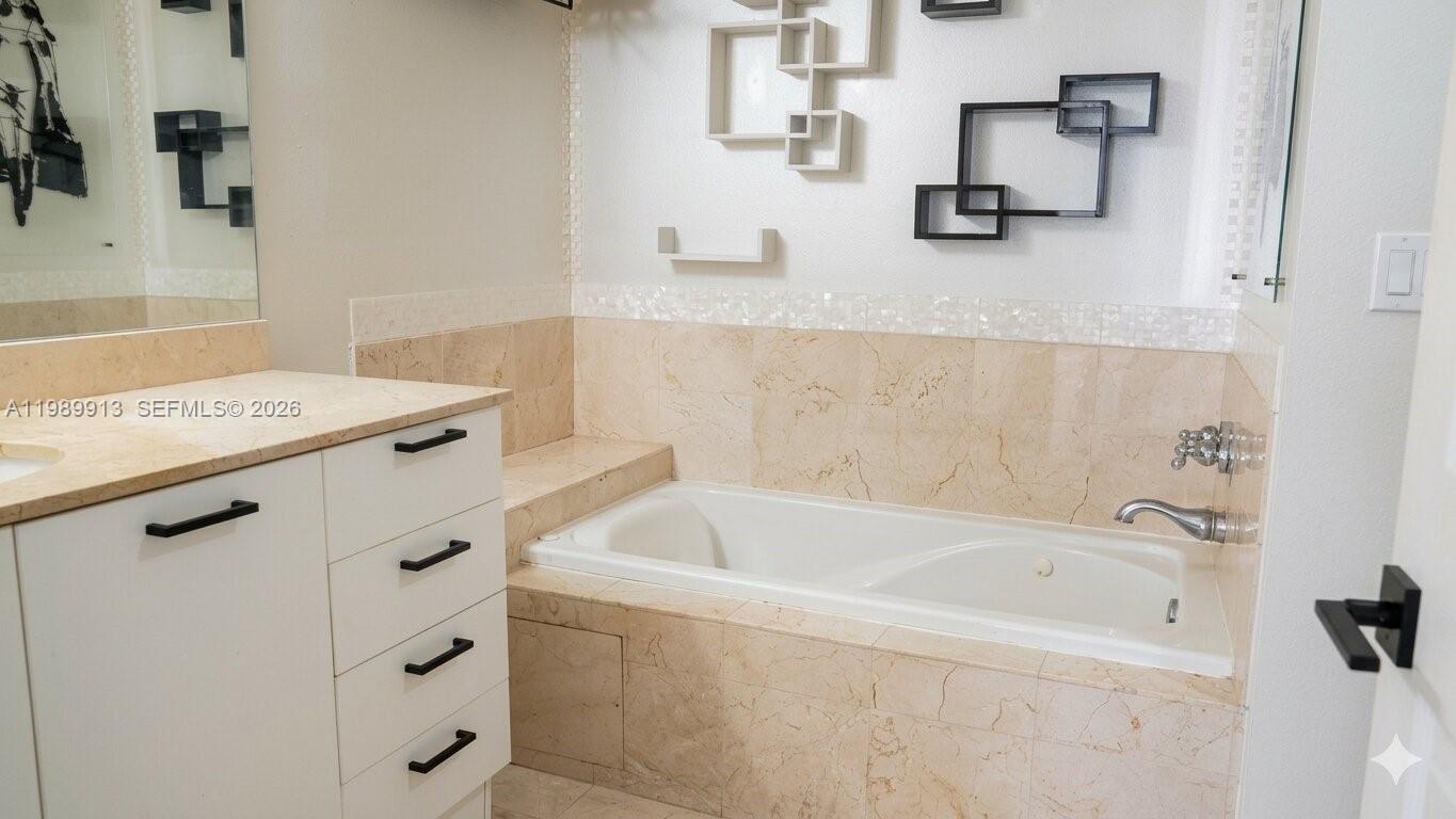 2030 Douglas Road, Unit 414 Coral Gables, FL 33134 - Photo 9 of 15 a bathroom with a bathtub and a sink