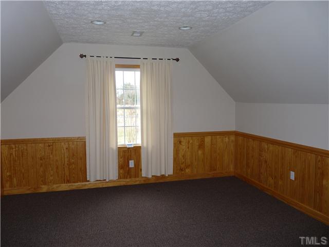 2178 Thee Hester Road Roxboro, NC 27574 - Photo 11 of 12 an empty room with wooden floor and windows