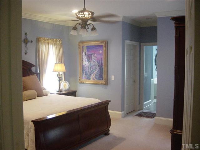 2178 Thee Hester Road Roxboro, NC 27574 - Photo 9 of 12 a bedroom with a bed and a chandelier