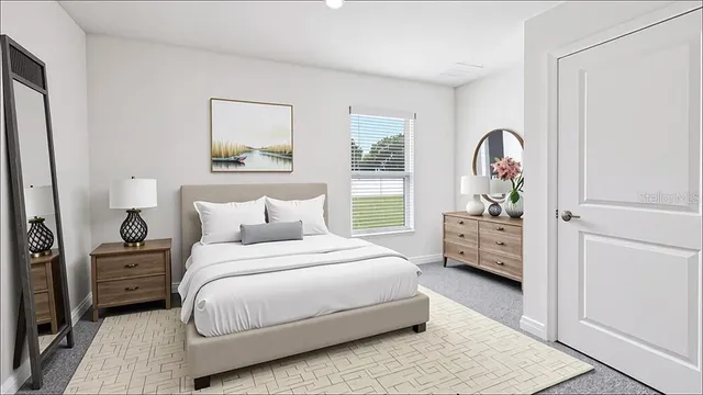 a bedroom with a bed and a dresser