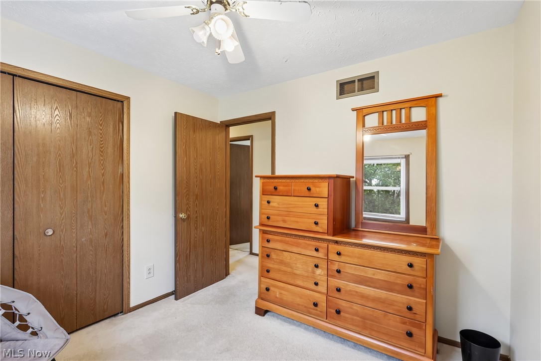 4702 Alger Road Richfield, OH 44286 - Photo 29 of 46 Bedroom with a closet, ceiling fan / light and carpet flooring