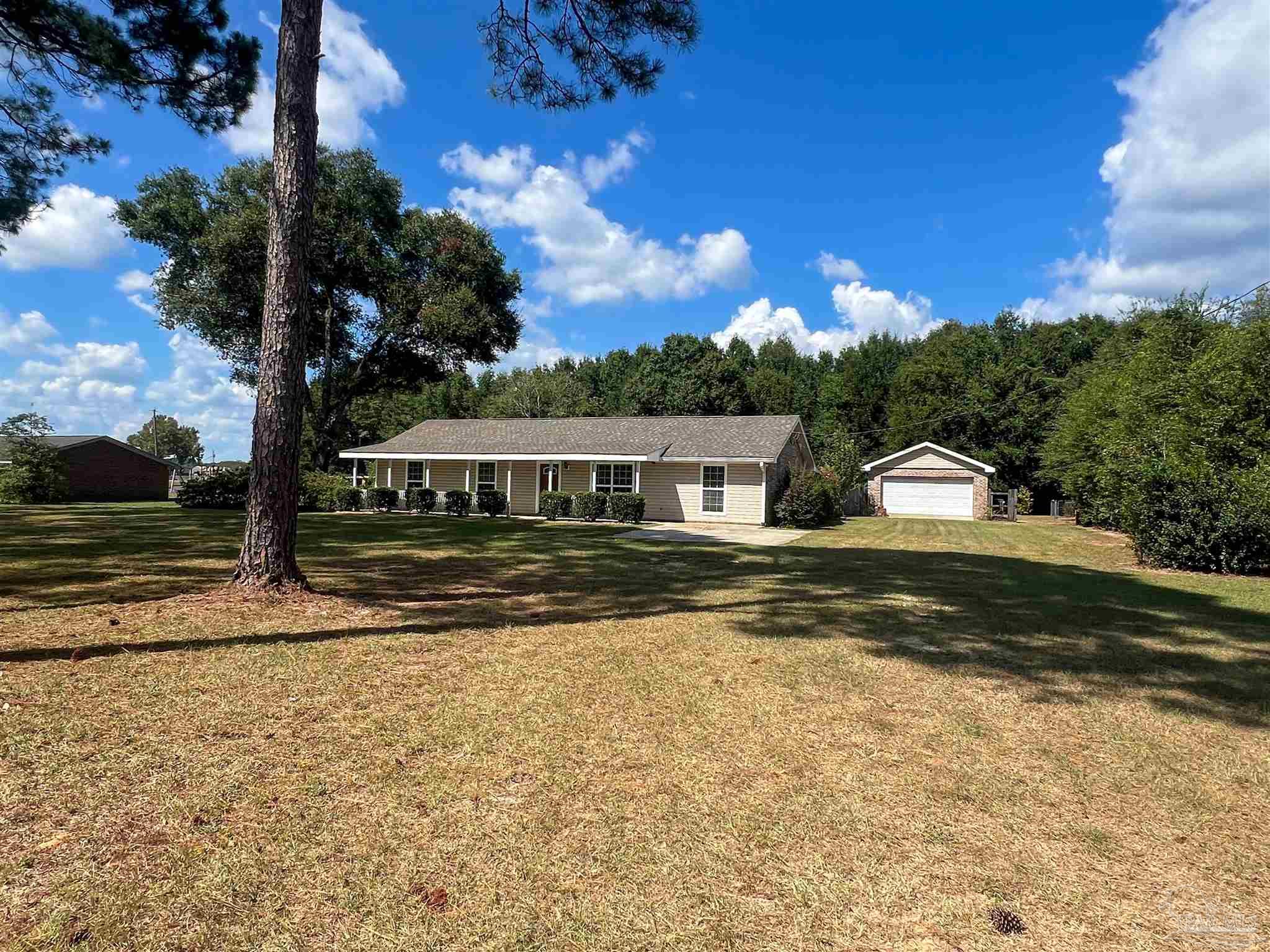 a front view of a house with a yard and mountain view