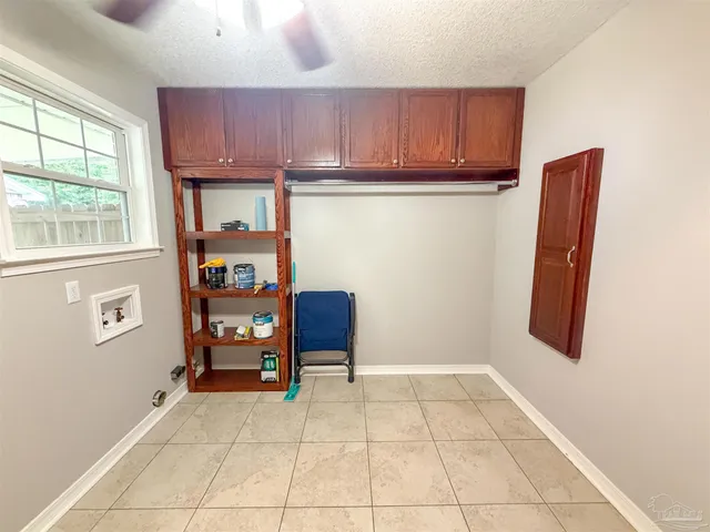 a view of kitchen with window and cabinets