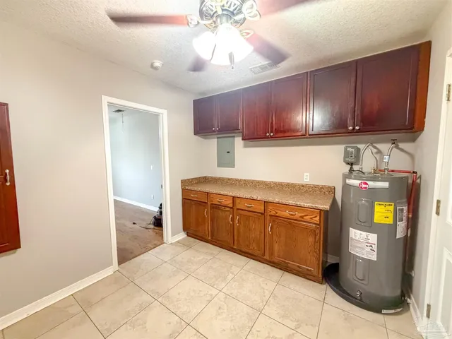 a kitchen with granite countertop a stove a sink and a cabinets