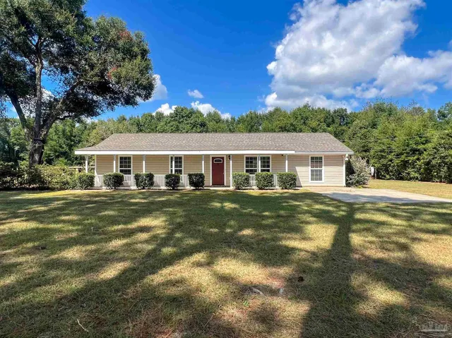 a front view of house with yard entertaining space and seating area