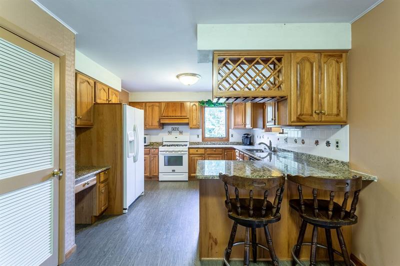 234 McKenzie Road Clinton, PA 15026 - Photo 7 of 24 Oak Kitchen w/Granite Counters and Tile Backsplash.