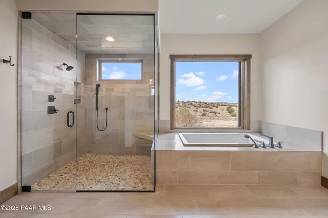 a living room with patio furniture and a floor to ceiling window