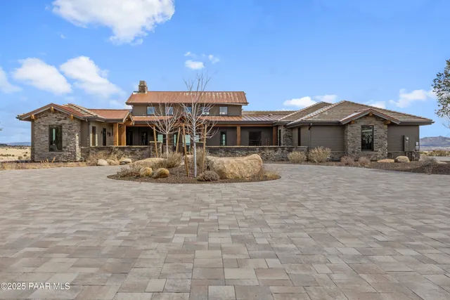 a living room with fireplace furniture and a floor to ceiling window