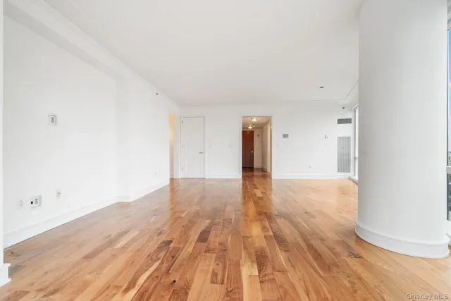 a view of an empty room and wooden floor