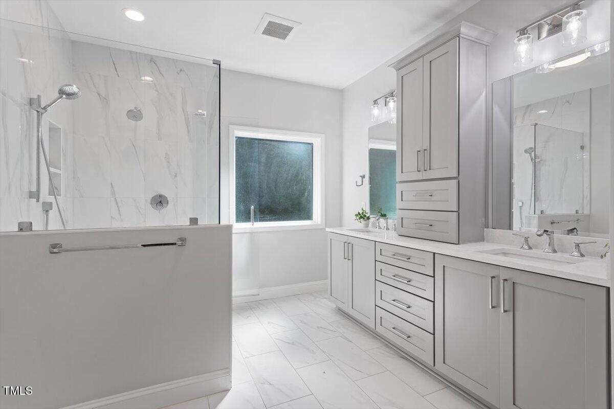 1913 Katesbridge Lane Raleigh, NC 27614 - Photo 17 of 38 a bathroom with a double vanity sink mirror and double