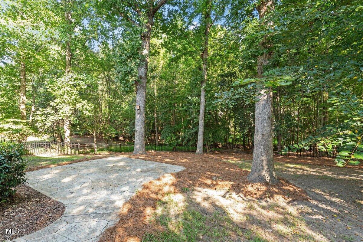 1913 Katesbridge Lane Raleigh, NC 27614 - Photo 30 of 38 a backyard of a house with lots of green space and fountain