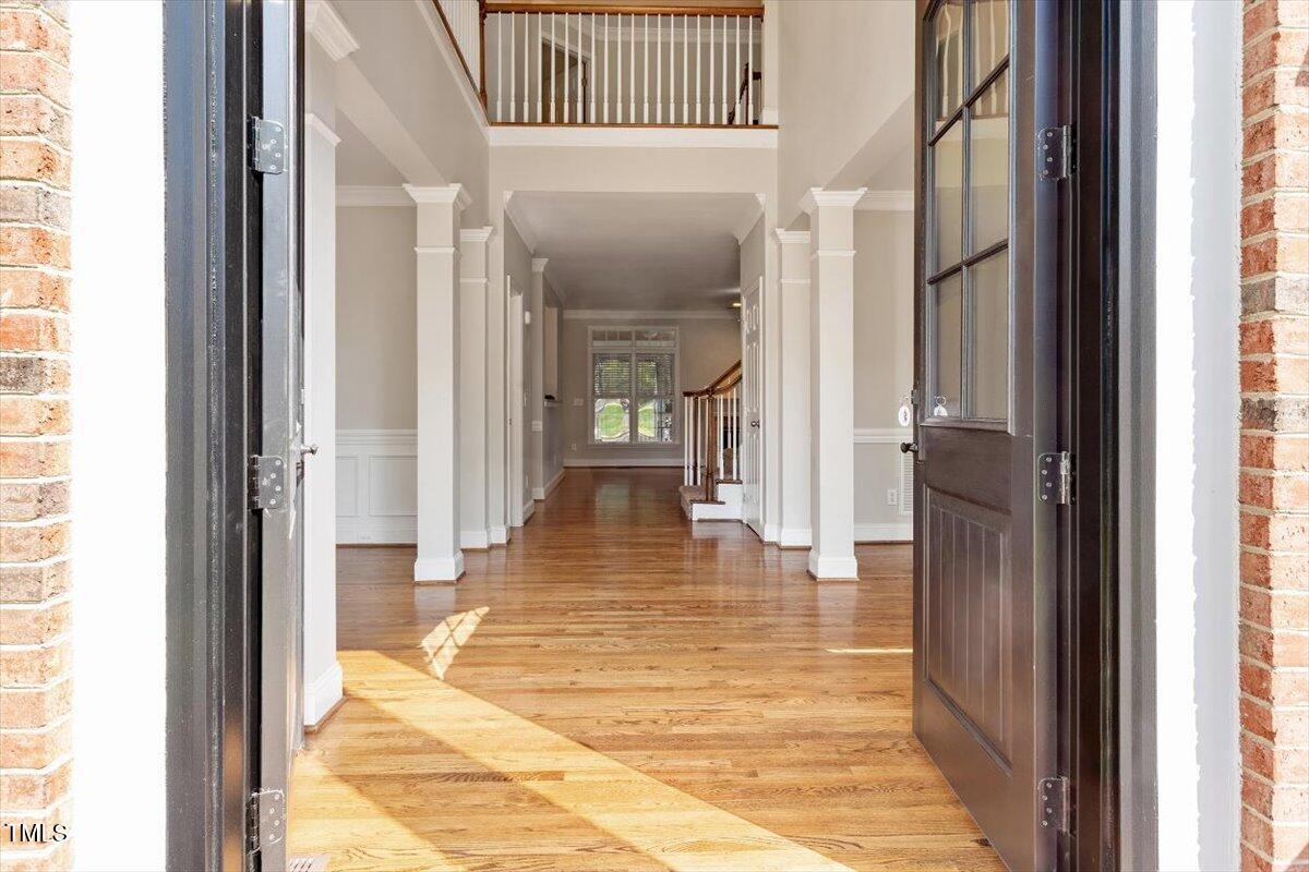 1913 Katesbridge Lane Raleigh, NC 27614 - Photo 3 of 38 a hallway with wooden floor a bedroom and windows