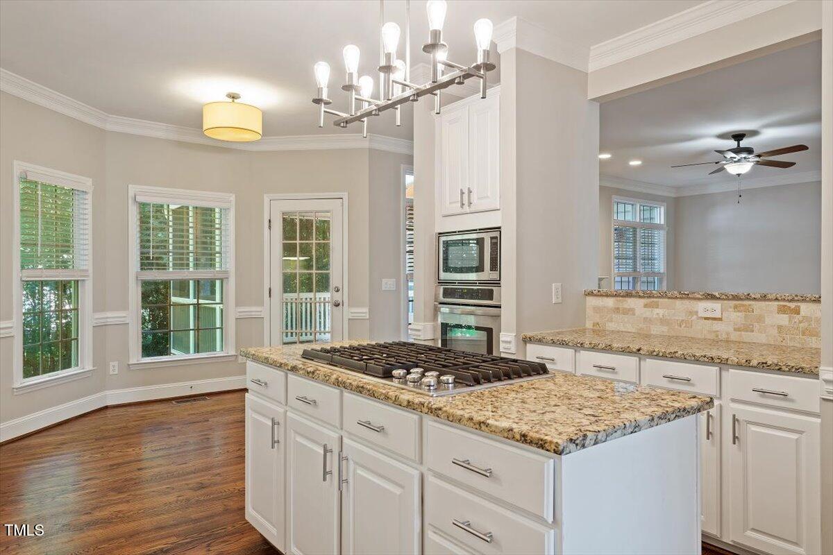 1913 Katesbridge Lane Raleigh, NC 27614 - Photo 5 of 38 a kitchen with a sink stove and chandelier