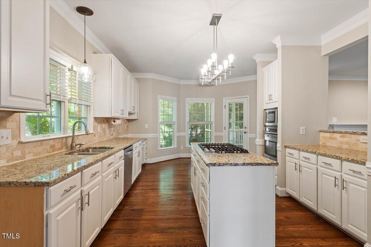 1913 Katesbridge Lane Raleigh, NC 27614 - Photo 6 of 38 a kitchen with stainless steel appliances granite countertop a sink stove and refrigerator