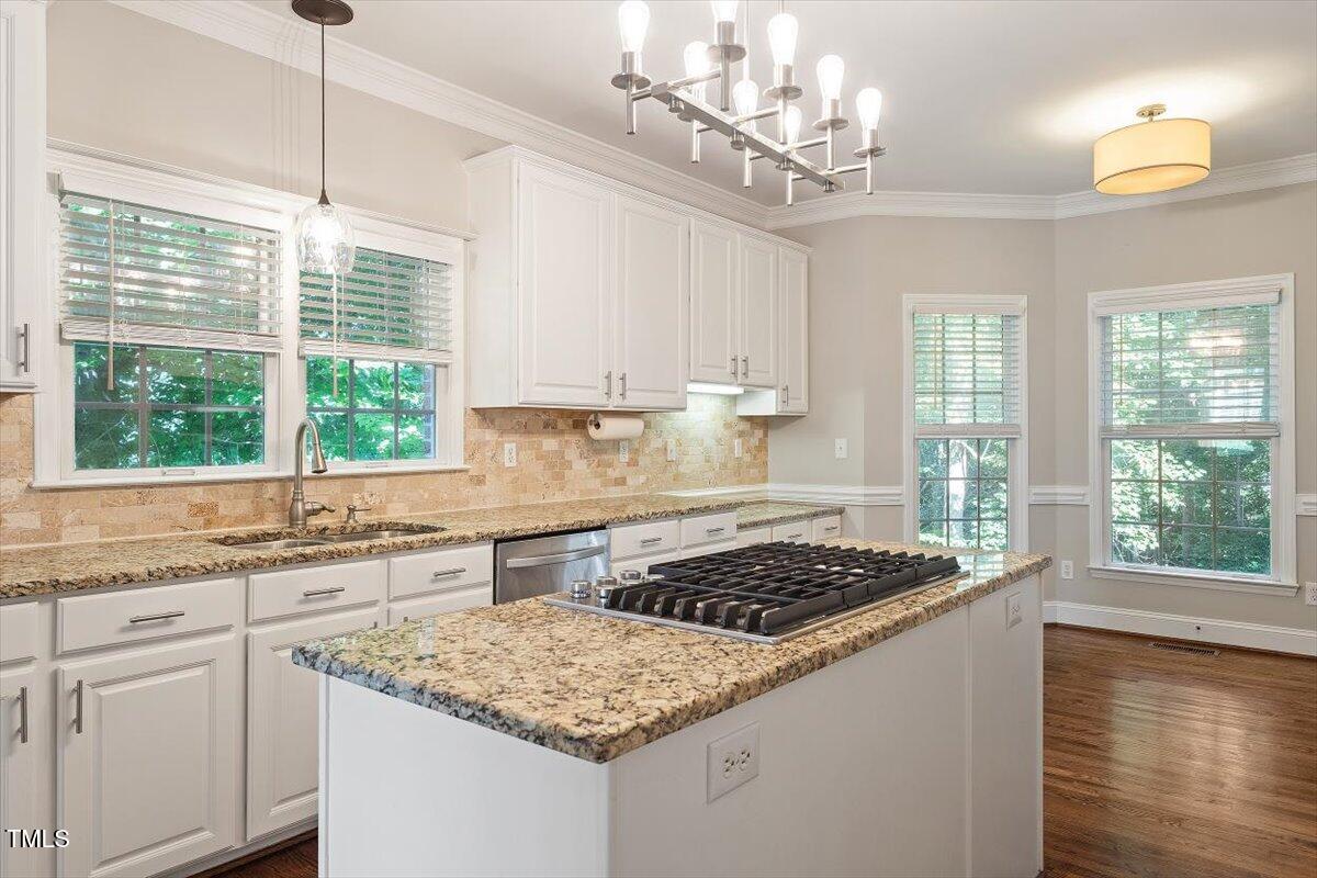 1913 Katesbridge Lane Raleigh, NC 27614 - Photo 7 of 38 a kitchen with a stove a sink a counter space and windows