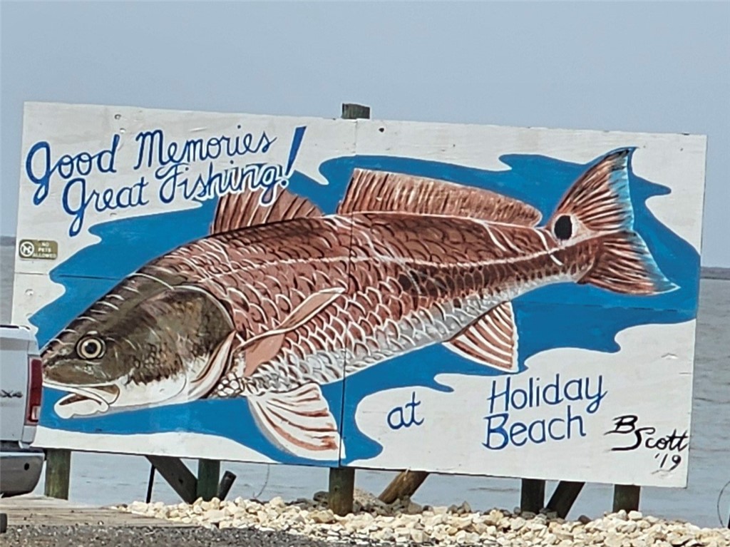 227 Palmetto Point Road Rockport, TX 78382 - Photo 10 of 10 a street sign on a wall next to a wall