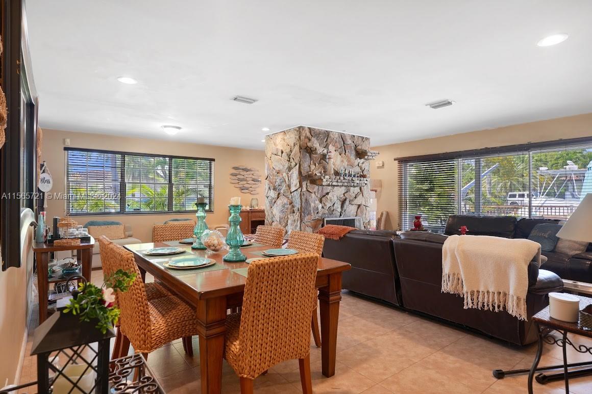 12735 Ixora Road Miami, FL 33181 - Photo 11 of 16 a dining room with furniture a large window and a table