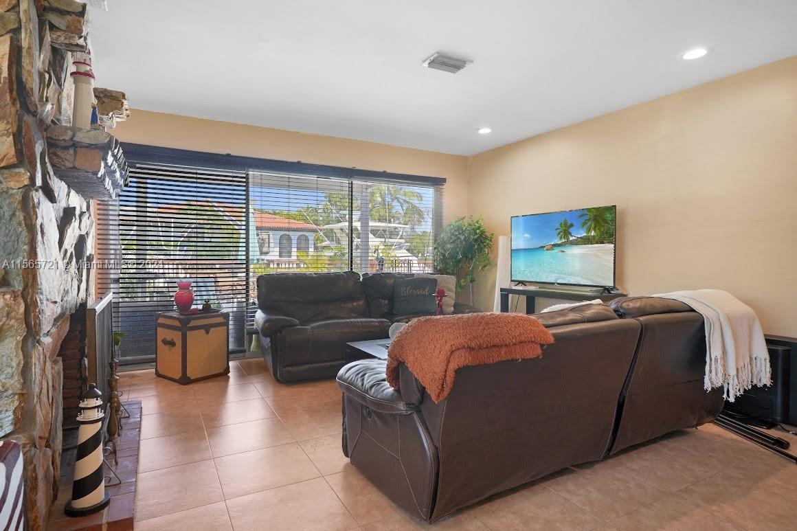 12735 Ixora Road Miami, FL 33181 - Photo 12 of 16 a living room with furniture and a flat screen tv