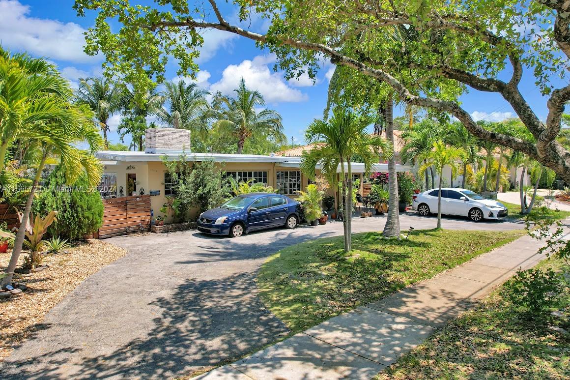 12735 Ixora Road Miami, FL 33181 - Photo 4 of 16 a view of a yard with cars parked