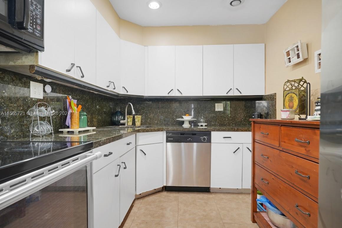 12735 Ixora Road Miami, FL 33181 - Photo 8 of 16 a kitchen with granite countertop a sink and cabinets