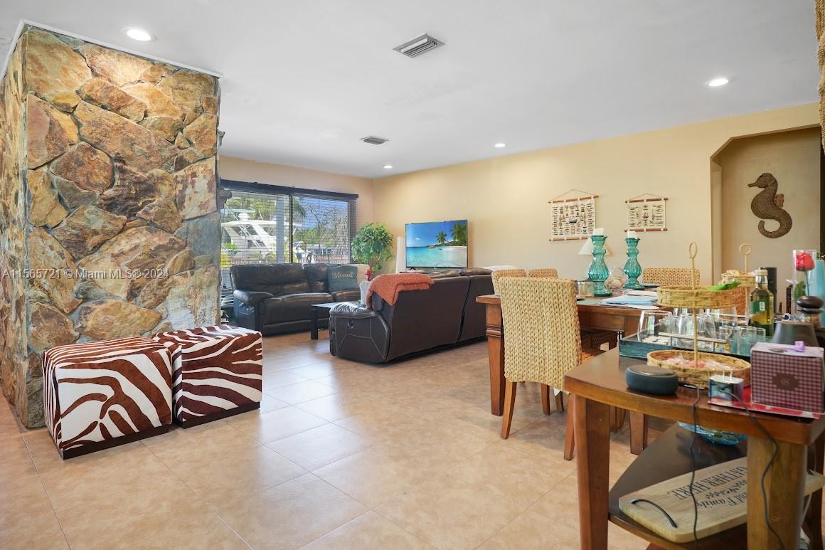 12735 Ixora Road Miami, FL 33181 - Photo 9 of 16 a living room with furniture a large window and a flat screen tv