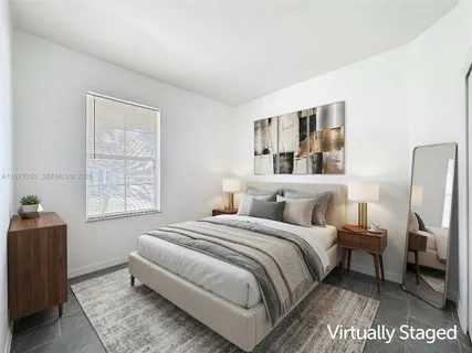 a bedroom with a large bed and a window
