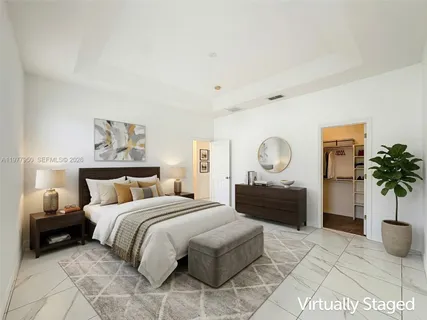 a bedroom with a bed and a potted plant