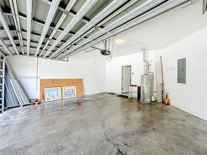 a front view of a house with a yard and potted plants
