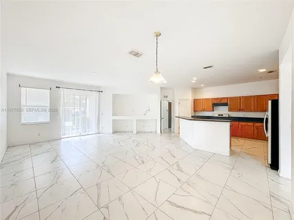 a view of a kitchen with marble kitchen and cabinets