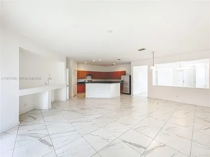 a view of a kitchen with white cabinets and white appliances