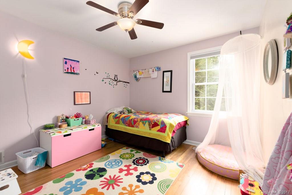 93 School Road Asheville, NC 28806 - Photo 11 of 24 a bedroom with a bed and wooden floor