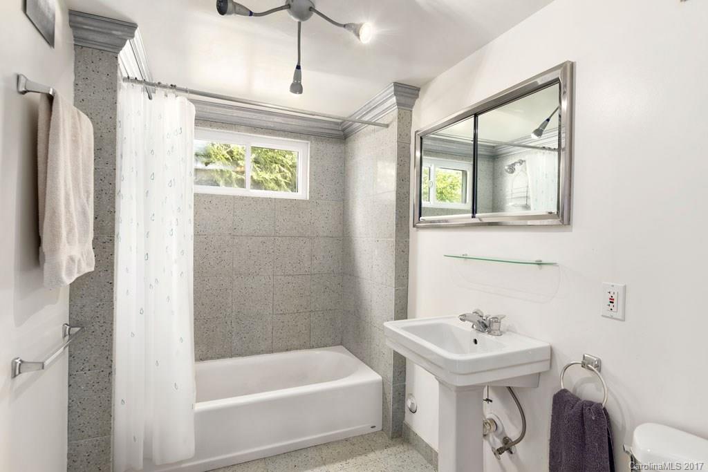 93 School Road Asheville, NC 28806 - Photo 18 of 24 a bathroom with a sink a bathtub and a shower