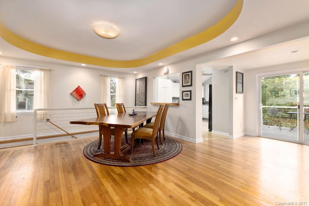 93 School Road Asheville, NC 28806 - Photo 3 of 24 a view of a dining room with furniture a chandelier and wooden floor