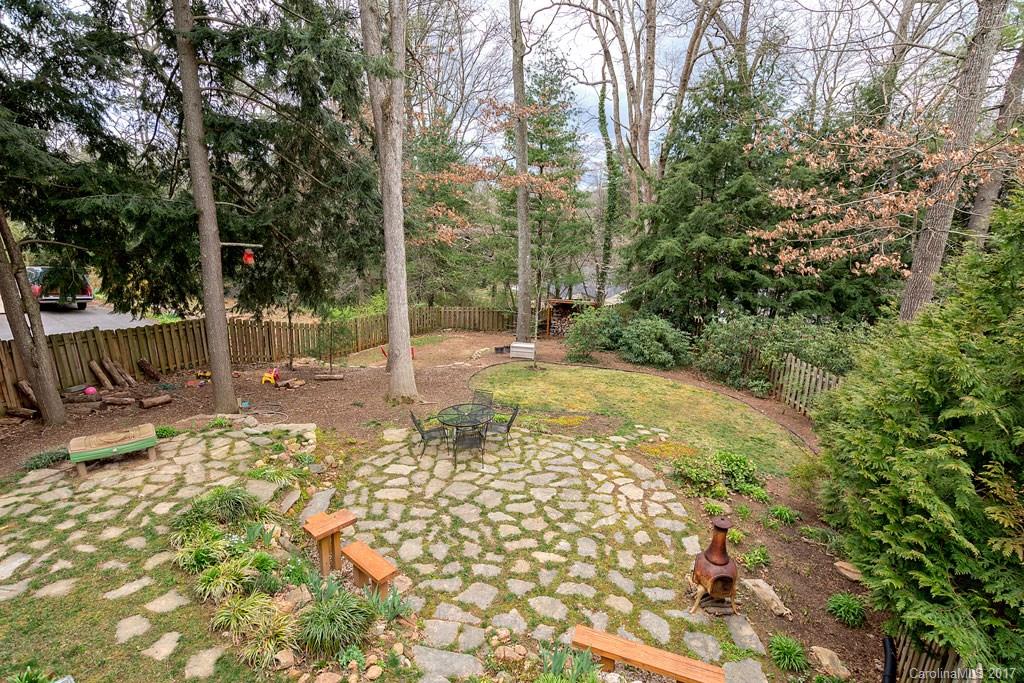 93 School Road Asheville, NC 28806 - Photo 22 of 24 a view of a yard with plants and large trees