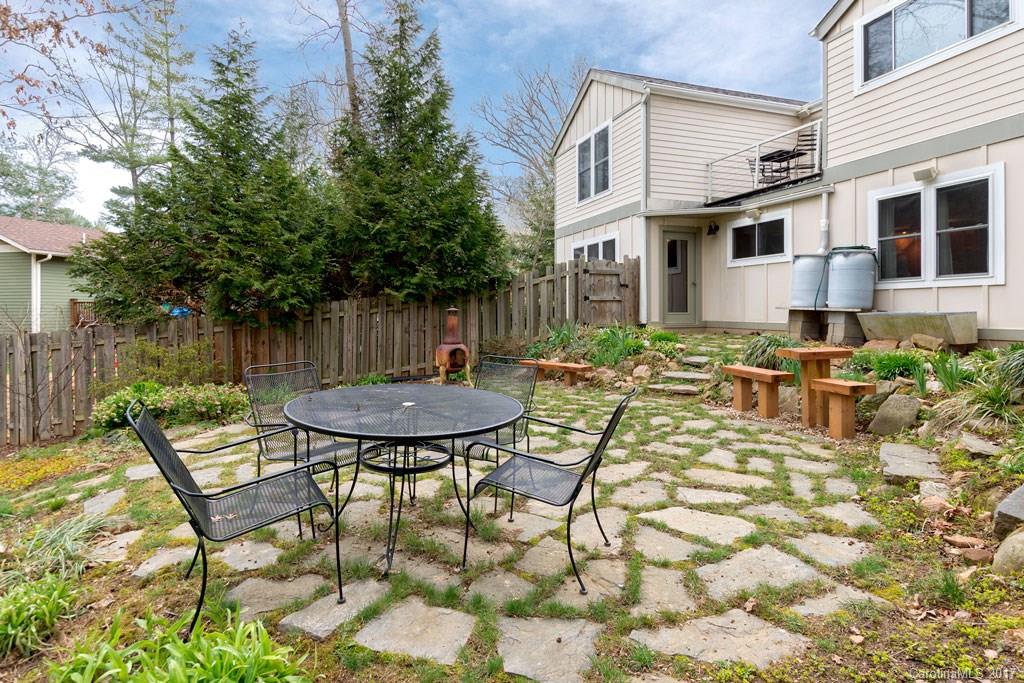 93 School Road Asheville, NC 28806 - Photo 23 of 24 a view of a backyard with table and chairs and potted plants