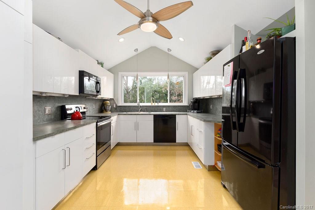 93 School Road Asheville, NC 28806 - Photo 5 of 24 a kitchen with stainless steel appliances a sink cabinets and a refrigerator