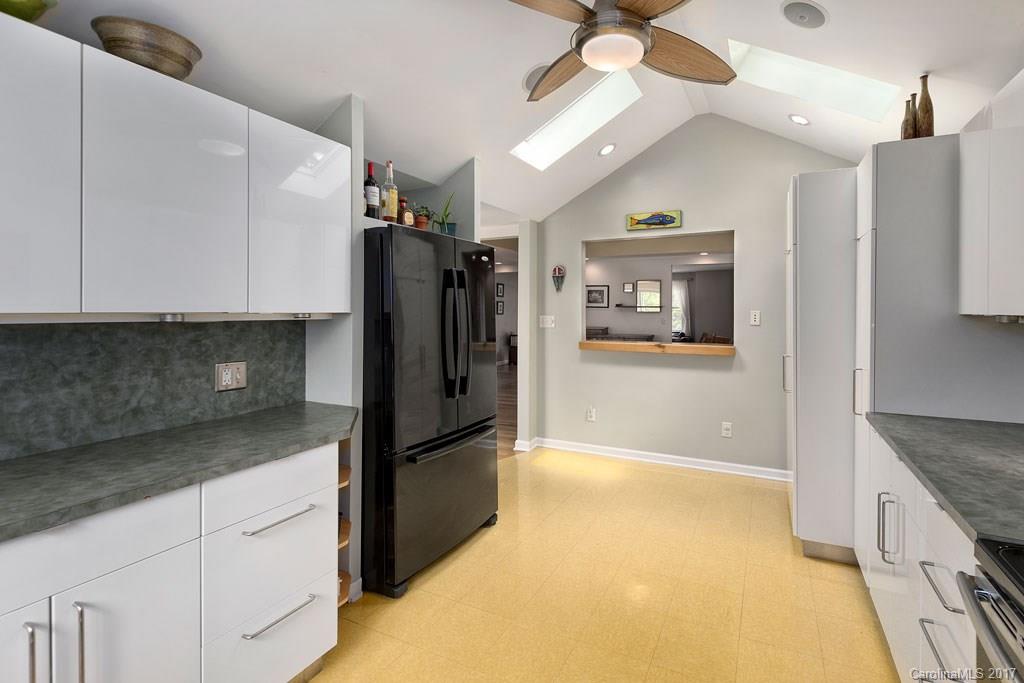 93 School Road Asheville, NC 28806 - Photo 7 of 24 a kitchen with granite countertop a refrigerator and a sink