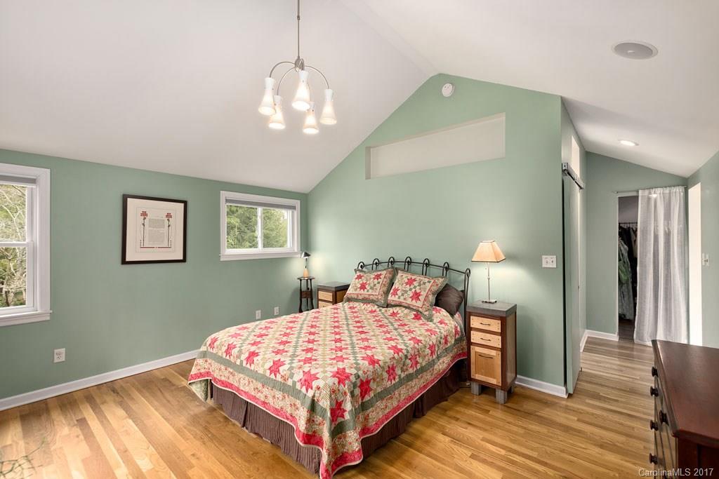 93 School Road Asheville, NC 28806 - Photo 9 of 24 a bedroom with a bed and a chandelier