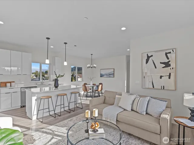 a view of kitchen with stainless steel appliances kitchen island granite countertop a living room