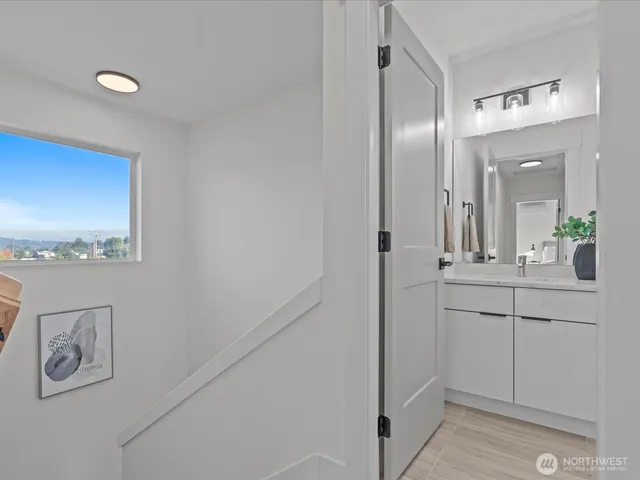 a bathroom with a sink a mirror and a window