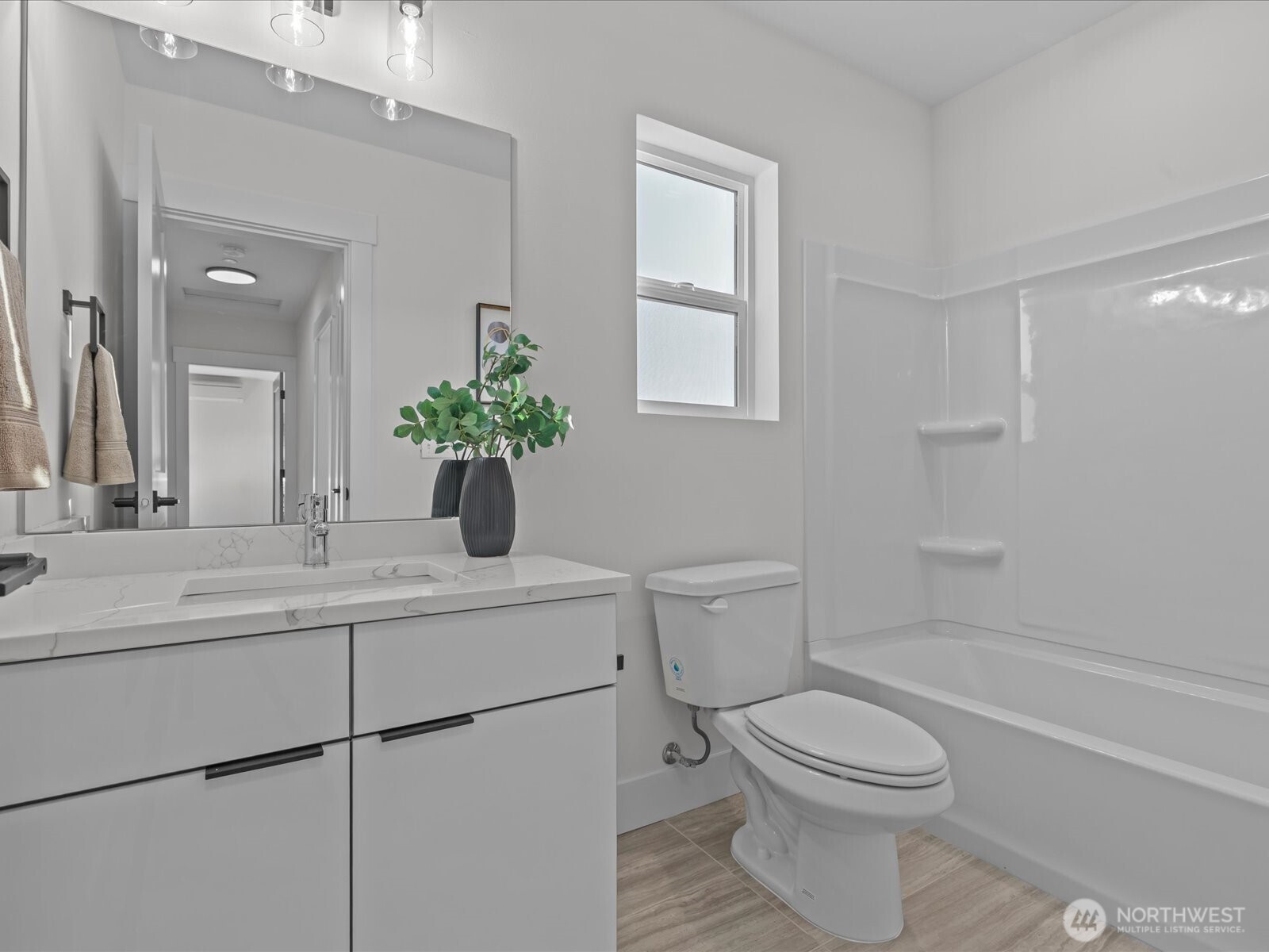 215 Corrin Avenue Northwest, Unit B Orting, WA 98360 - Photo 16 of 36 a bathroom with a sink a toilet and shower