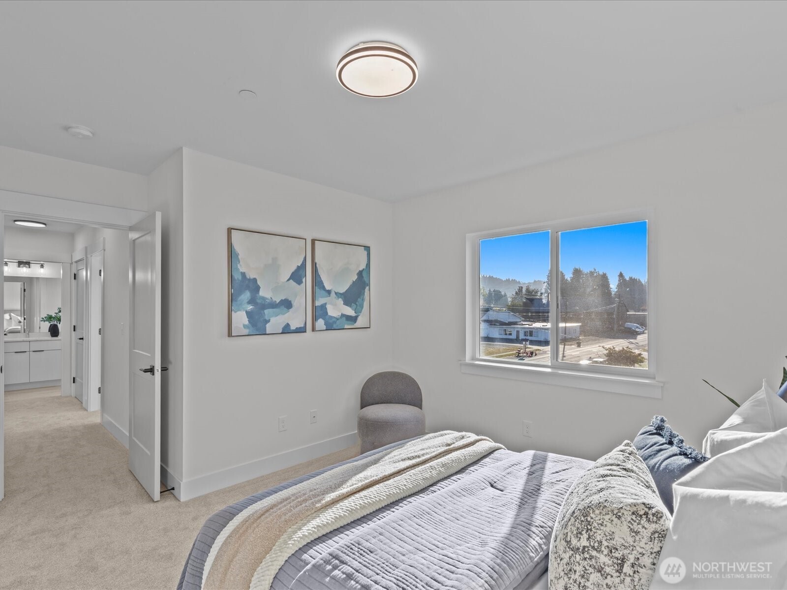 215 Corrin Avenue Northwest, Unit B Orting, WA 98360 - Photo 21 of 36 a bedroom with a bed and a painting on the wall