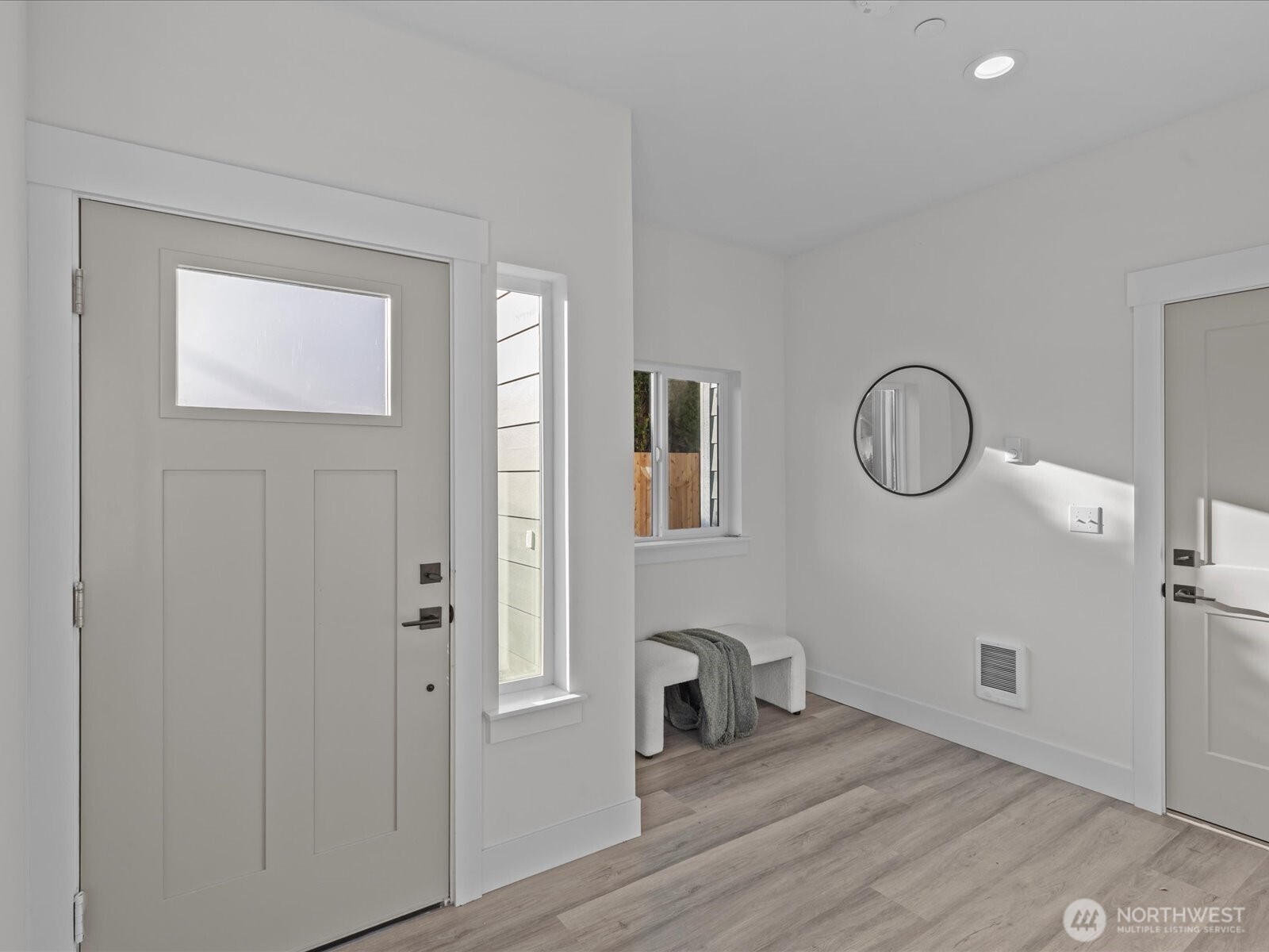215 Corrin Avenue Northwest, Unit B Orting, WA 98360 - Photo 5 of 36 a view of a room with wooden floor mirror and windows
