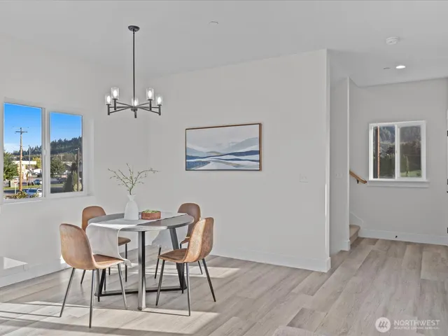 a dining room with furniture and chandelier