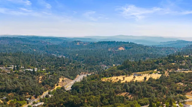 a view of a houses with a lush green hillside