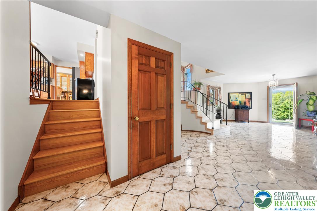 947 Tamenend Road Bath, PA 18014 - Photo 6 of 61 A grand entrance with hexagonal tile flooring and dual wooden staircases welcomes you inside.