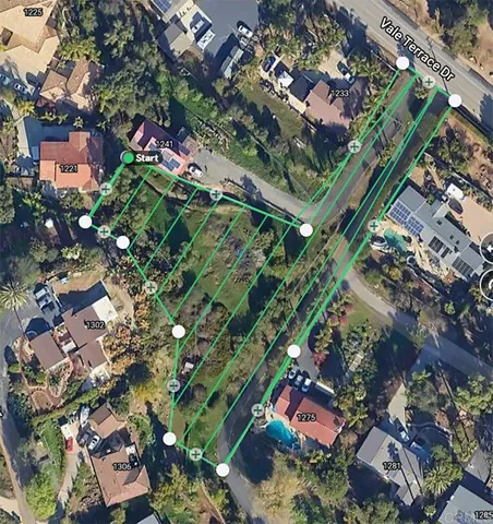 an aerial view of a residential apartment building with a yard and plants