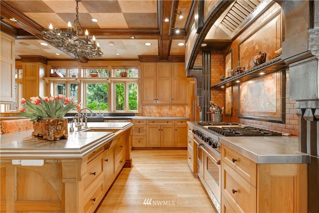 a living room with furniture a chandelier and large windows
