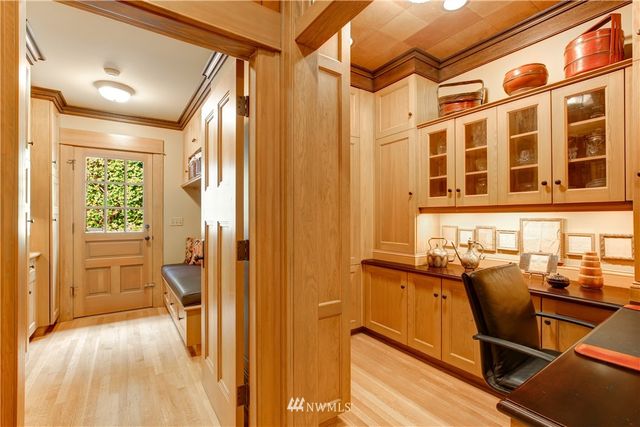 a spacious bedroom with a bed a table and large windows